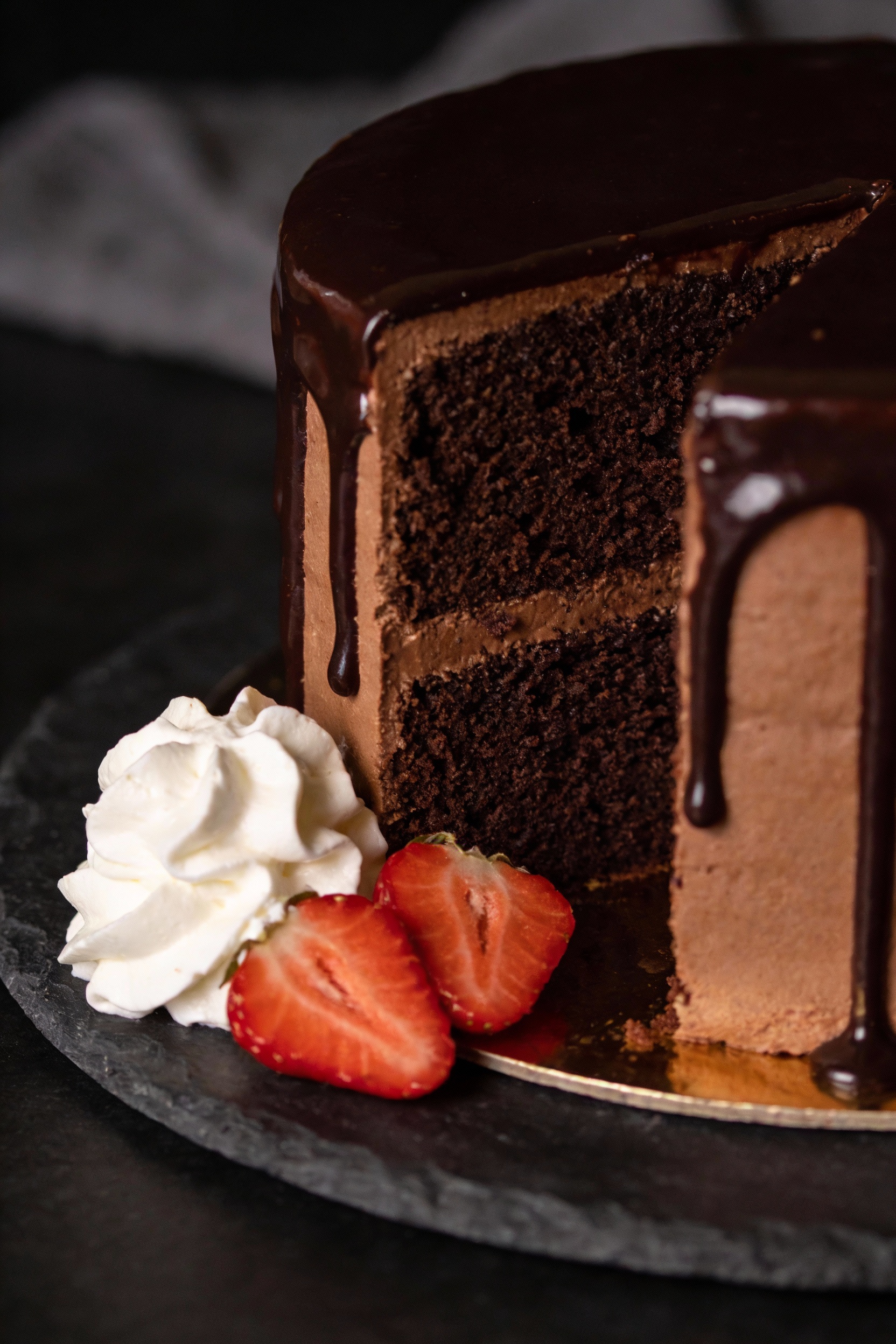 4. Final presentation: two-layer chocolate version with glossy dark chocolate ganache drip, neat cake edges, slice remov