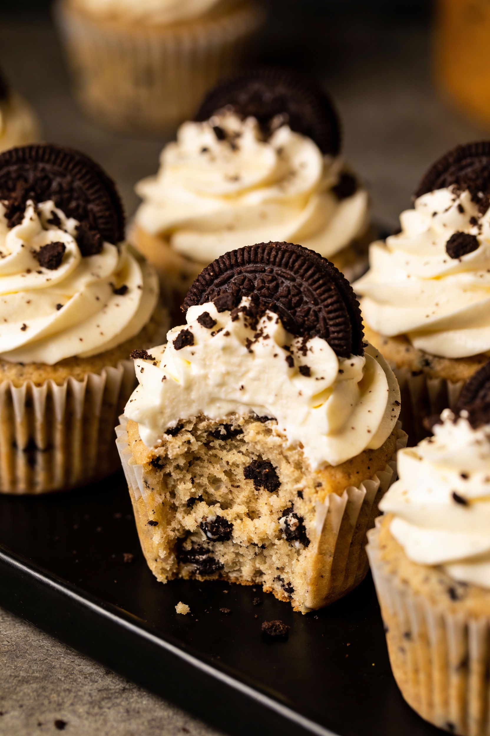 Final dish: cookies and cream cupcakes with tall cream cheese frosting swirls and crushed chocolate sandwich cookie crum